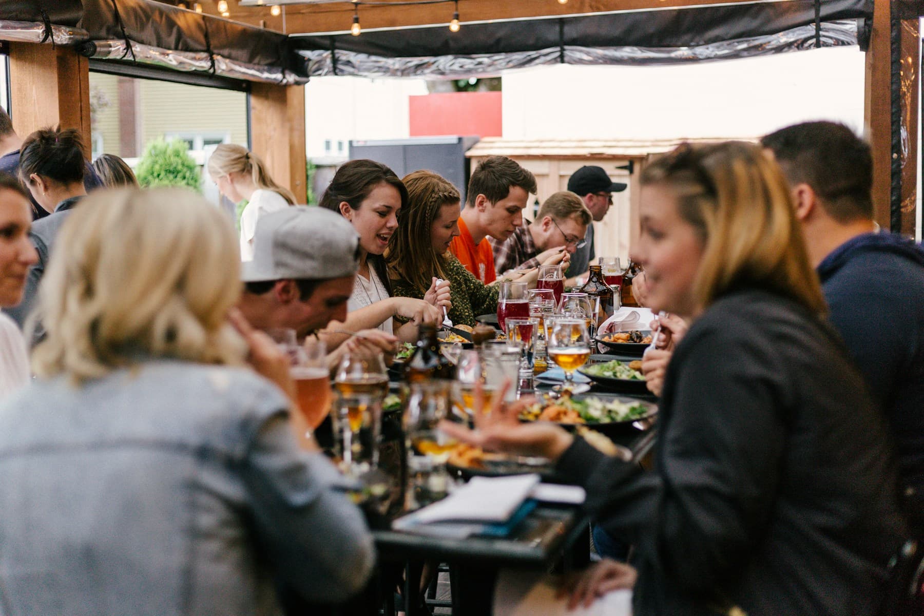 A host welcoming people at a shared table